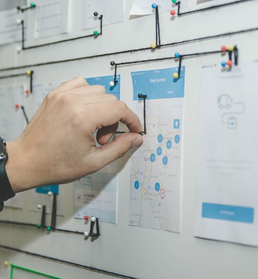 person working on blue and white paper on board