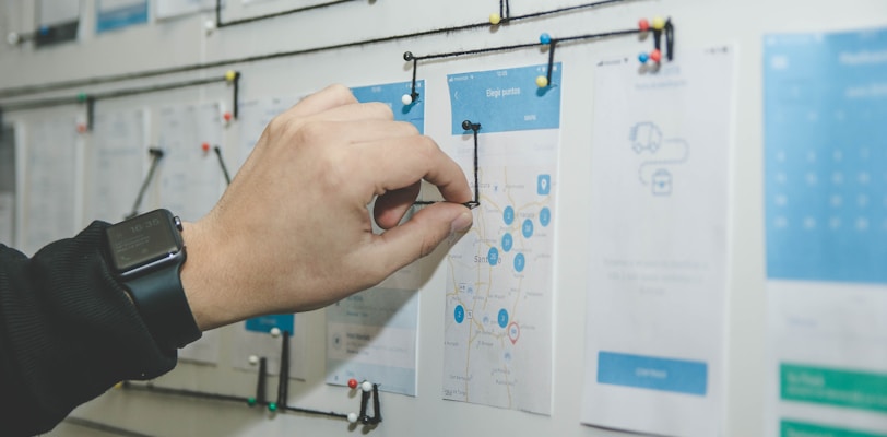 person working on blue and white paper on board