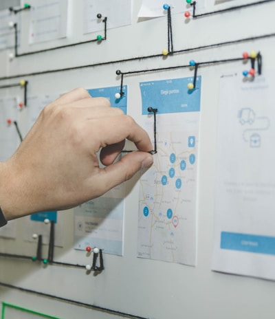 person working on blue and white paper on board