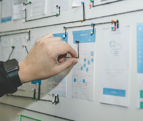 person working on blue and white paper on board