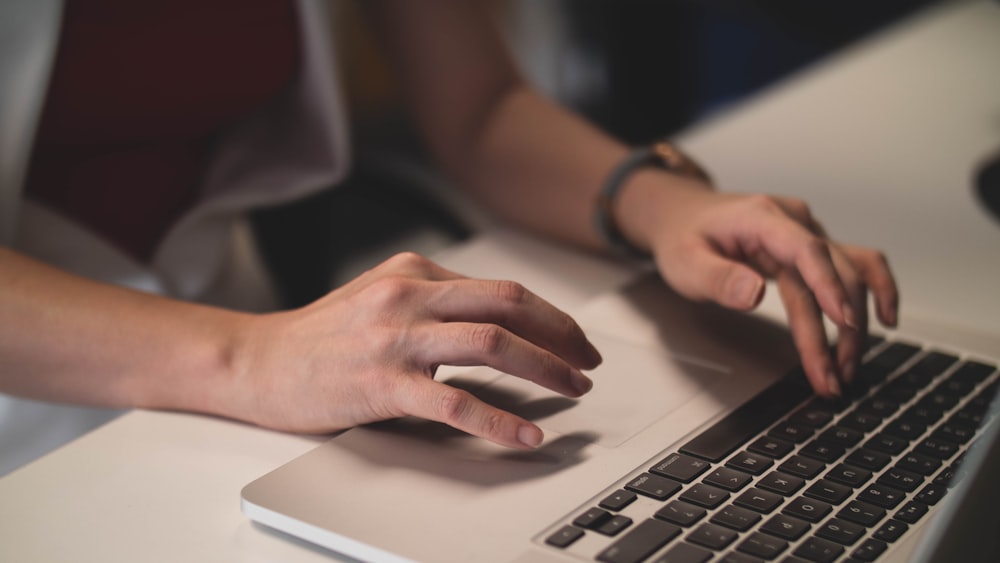 person using gray laptop computer