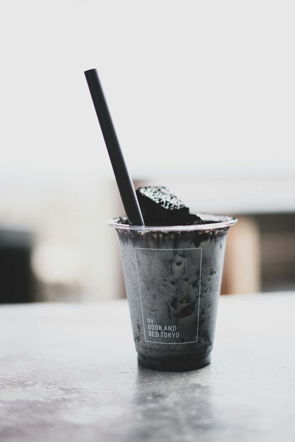 black beverage with sipping straw