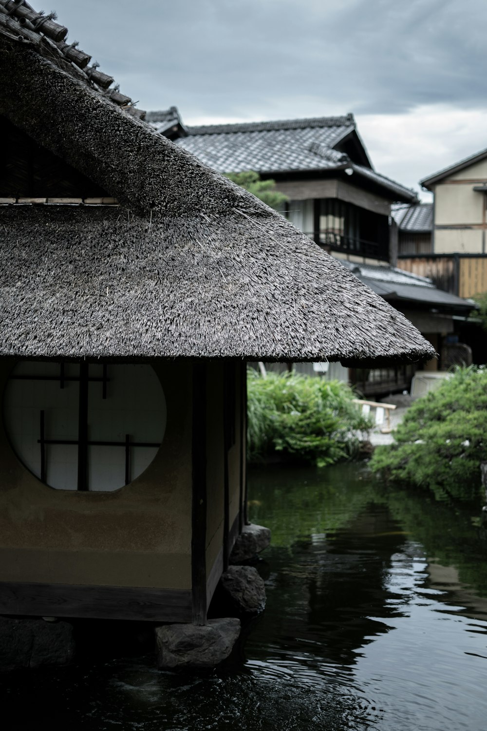 brown wooden house on water