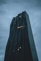 black high rise building under gray sky