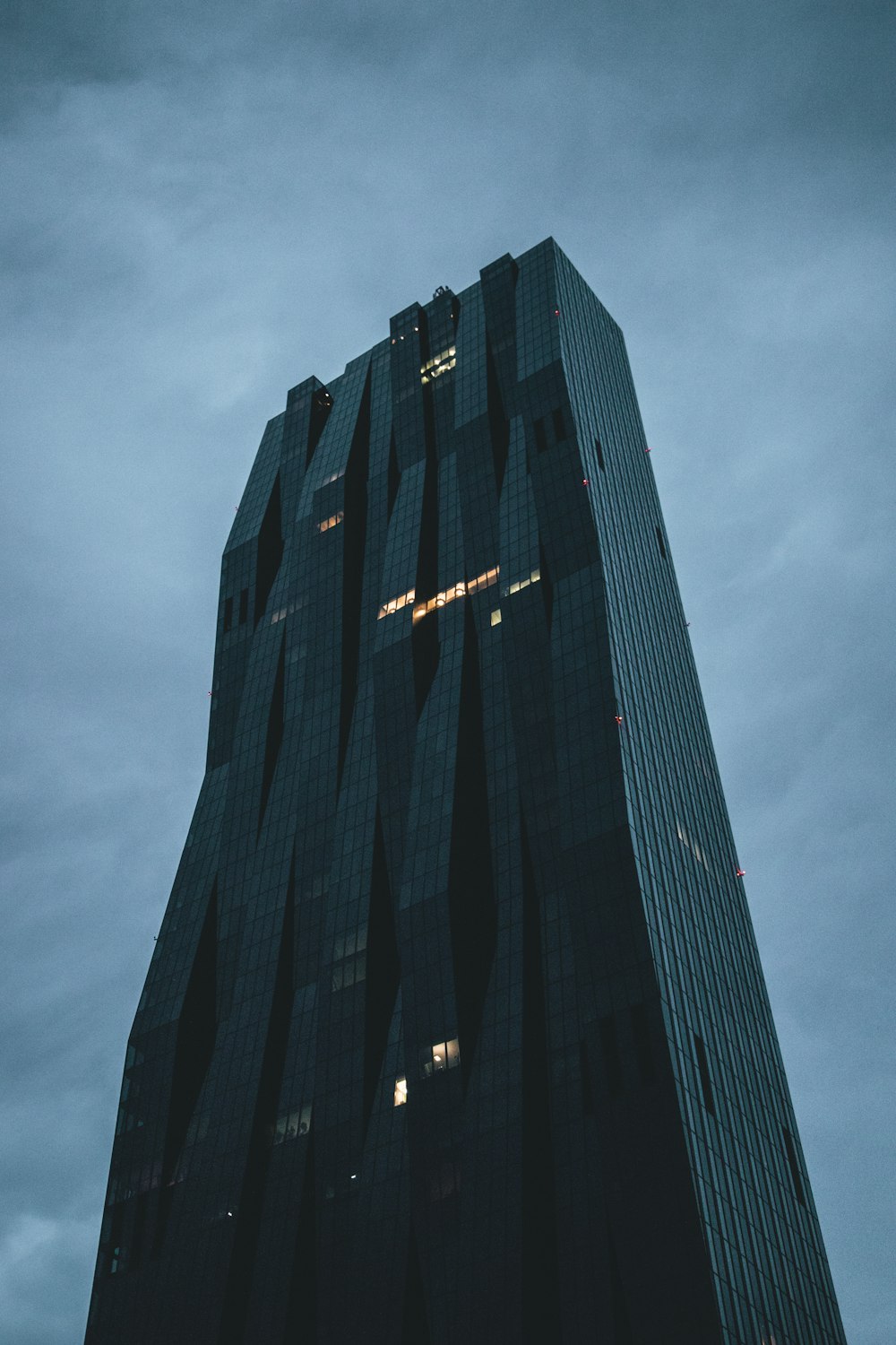 black high rise building under gray sky