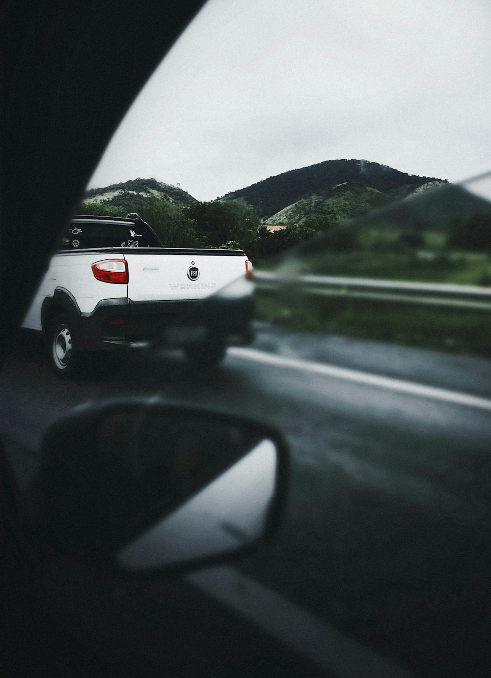 white pickup truck travelling on road