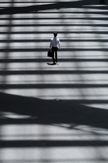 man holding laptop bag walking on street, Why do an MBA program