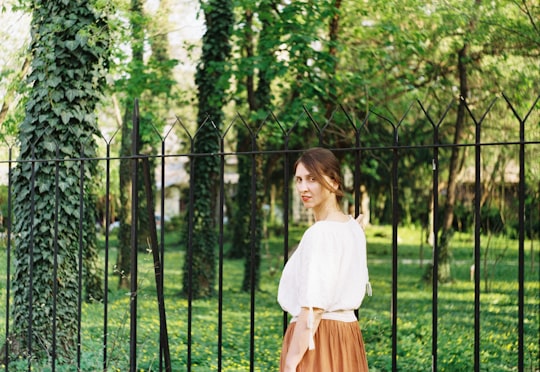 woman standing on front of black metal fence in Bucharest Romania