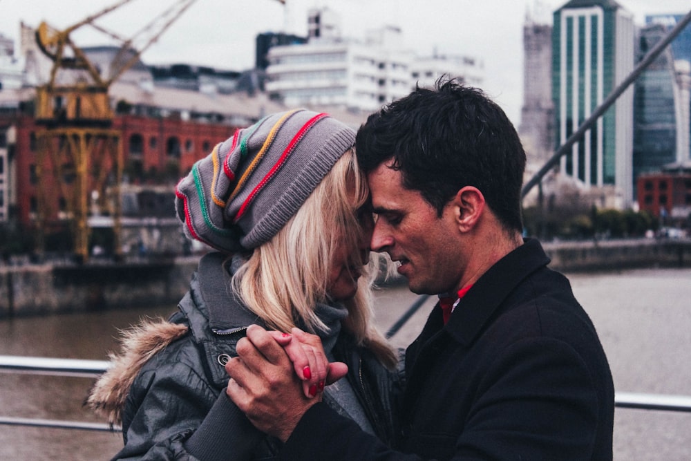 man and woman dancing beside body of water