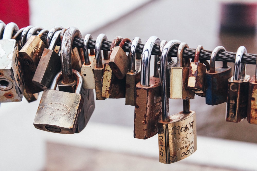 shallow focus photography of padlocks in steel cable