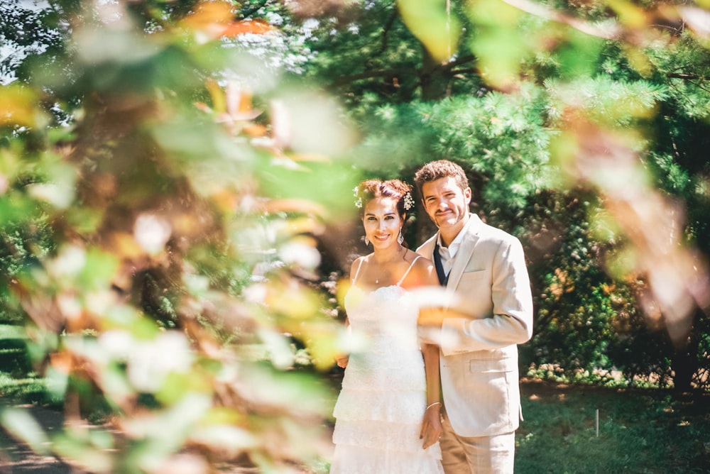 groom and bride near trees