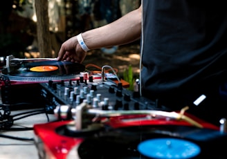 man in black shirt using DJ controller