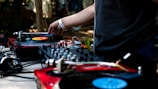man in black shirt using DJ controller