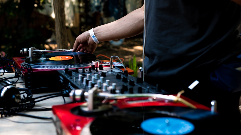 man in black shirt using DJ controller