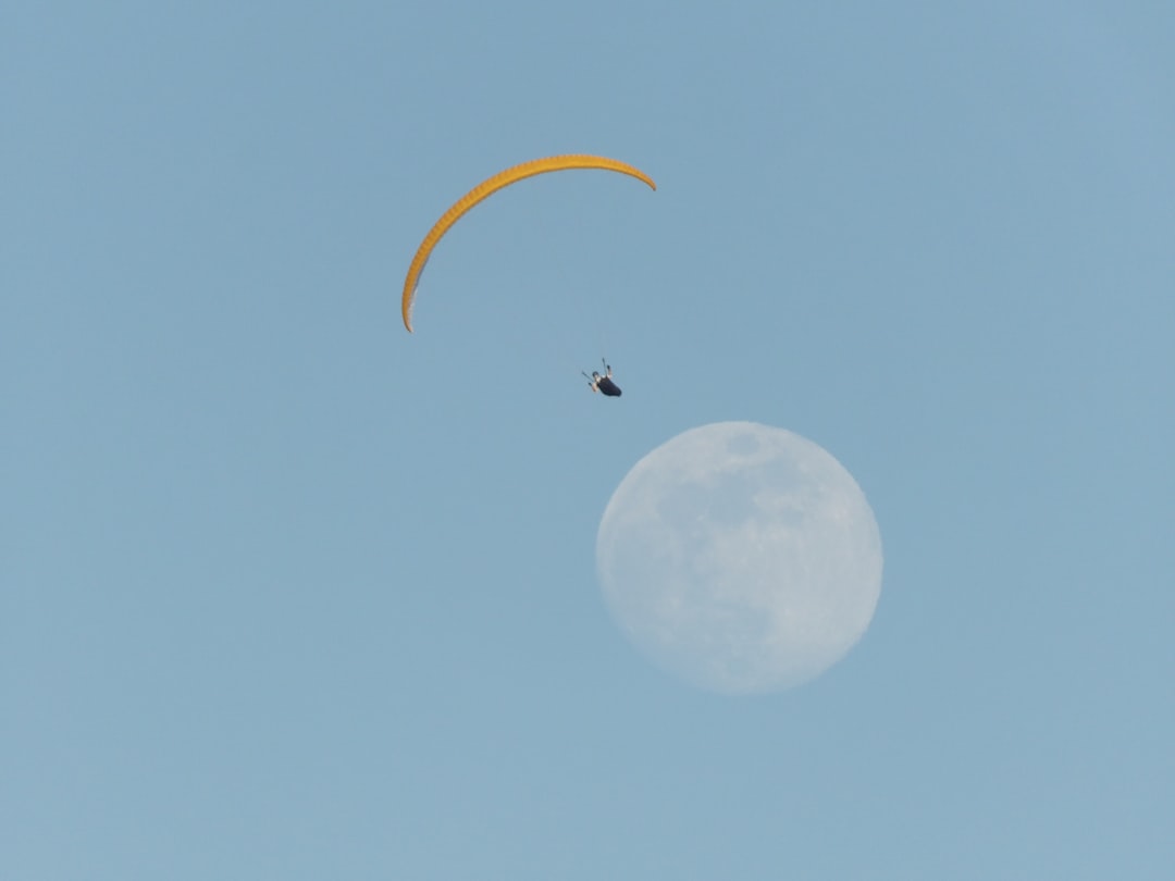 person on parachute with moon background, This photo was taken in the area of Mani (Greece) and specifically in the village of Karavostasi.</p></figure><p>It was around 6:30 pm and as I enjoyed my girlfriend the great food and the quiet of the area, we were looking at the wonderful image that this parachutist made us think in close proximity to the moon … the result you see!</p><p>Feel the feeling of freedom in the quiet of loneliness.