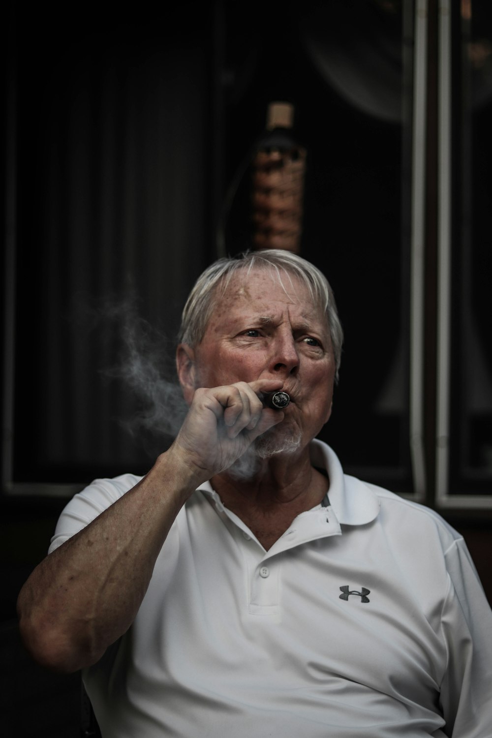 selective focus photography of man using tobacco
