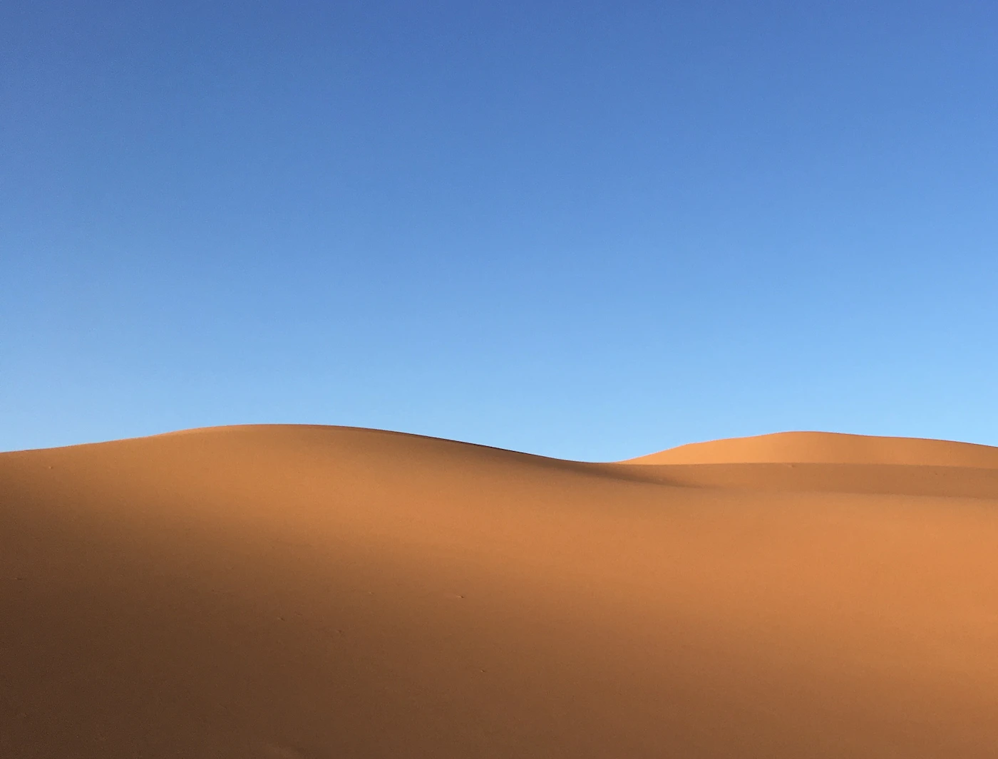 Rolling desert sand dunes