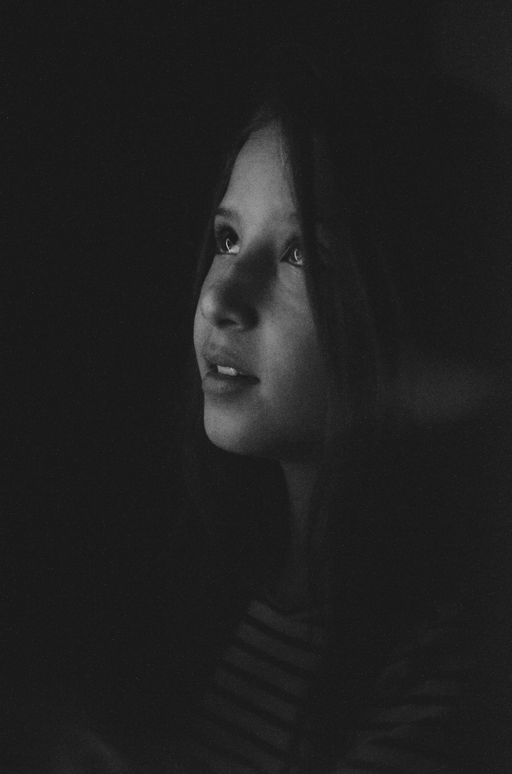 grayscale photography of a girl looking up