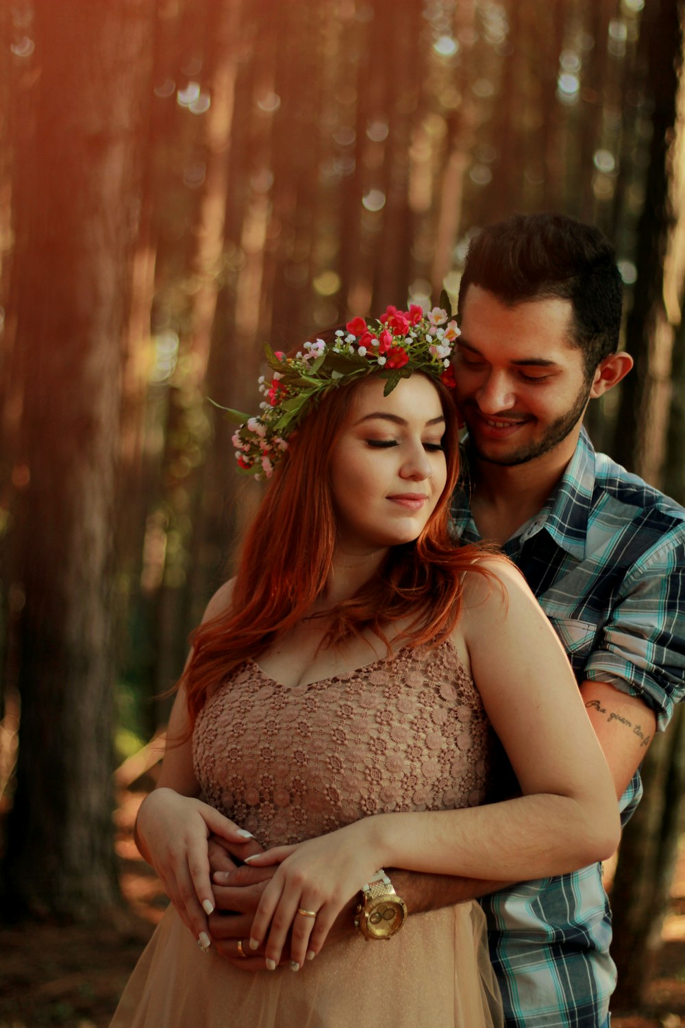 man hugging woman with flower crown