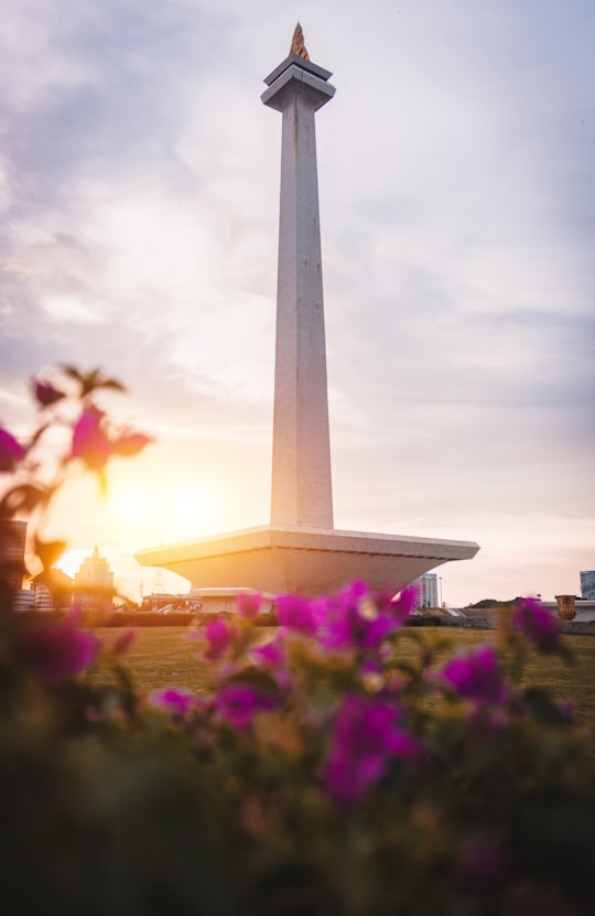 gray concrete tower under white clouds during daytime in National Monument Indonesia