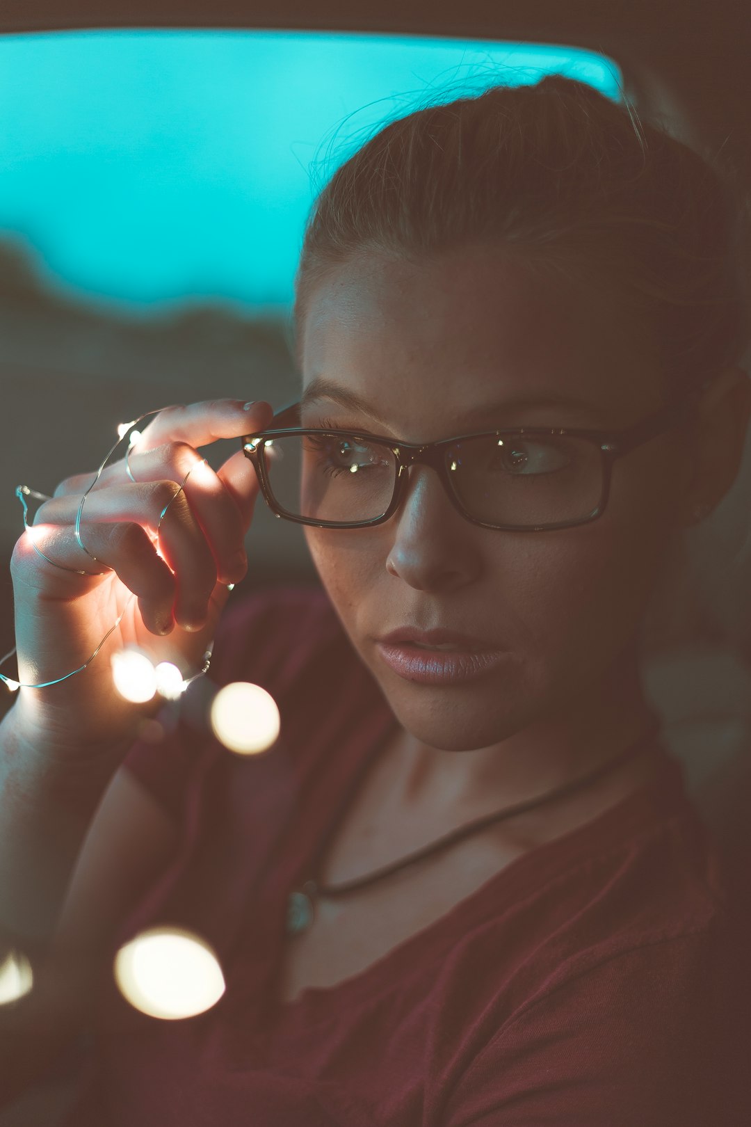 woman holding her eyeglasses