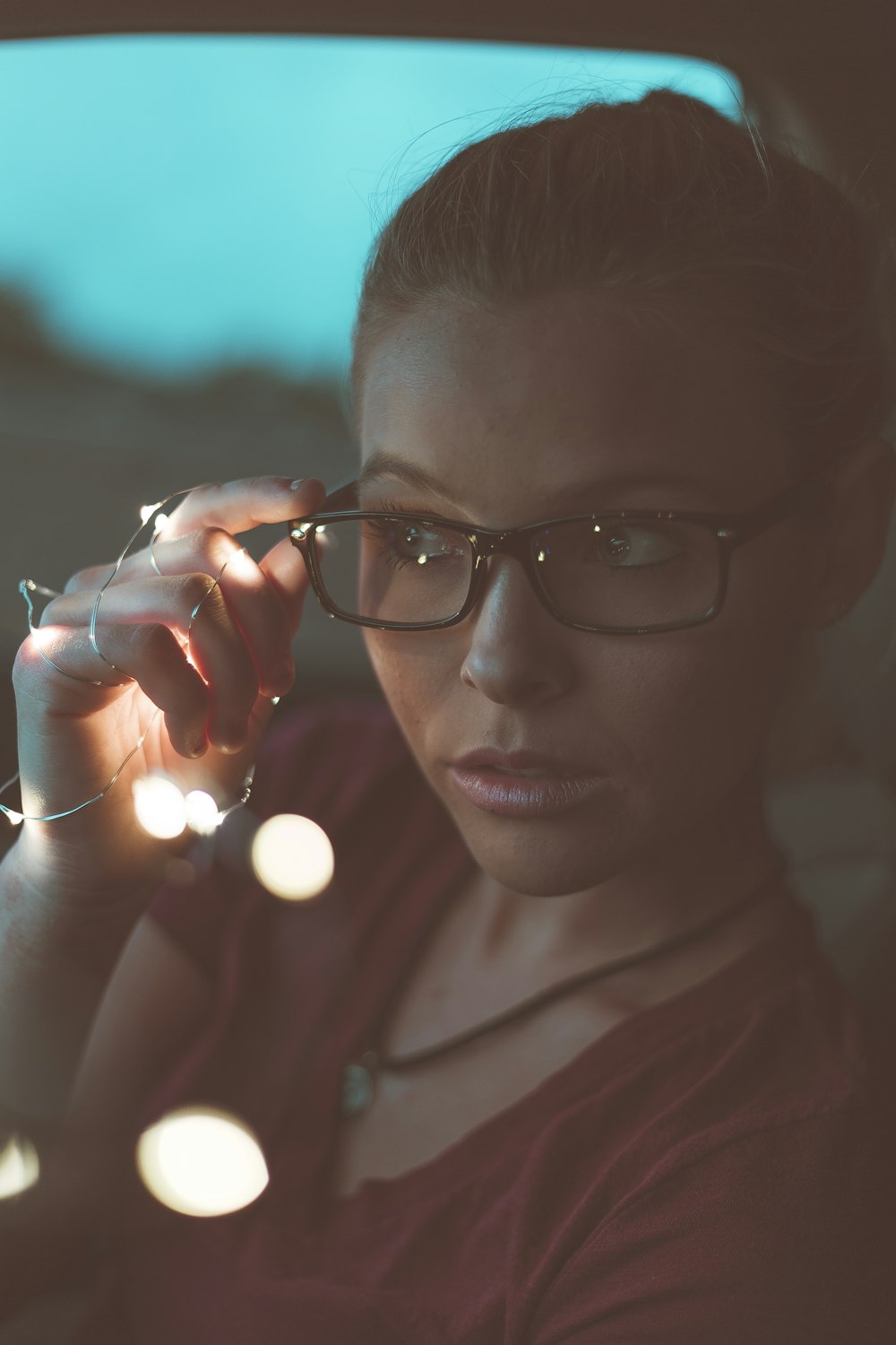 woman holding her eyeglasses