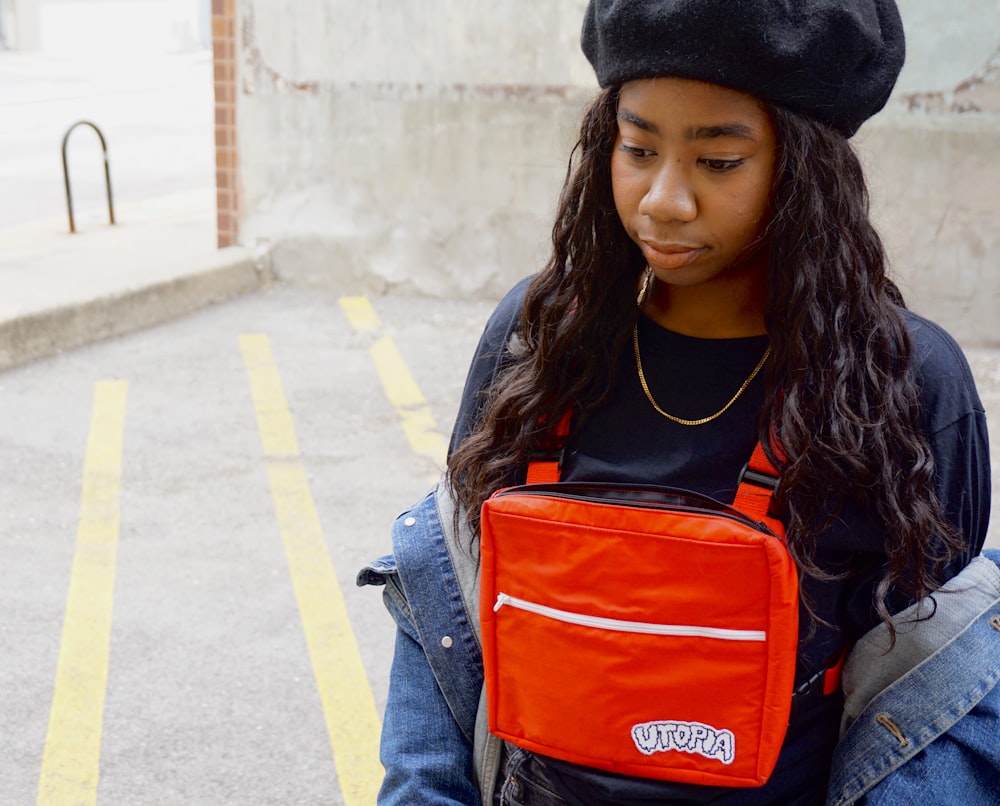 woman carying red bag