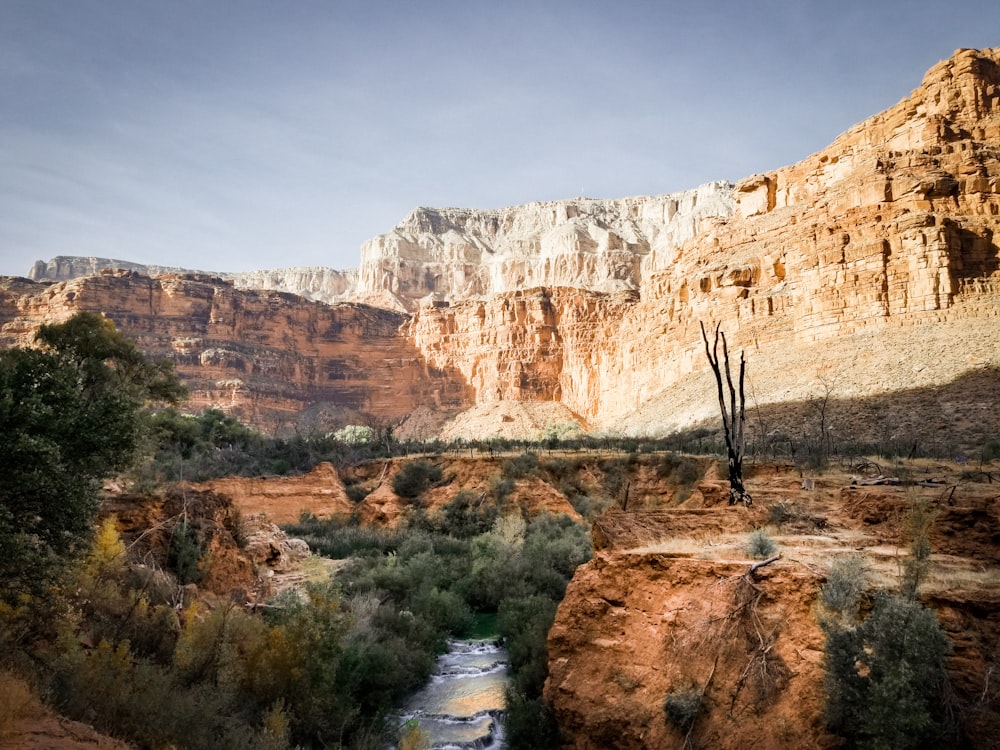 photo of mountain cliff near body of water during daytime