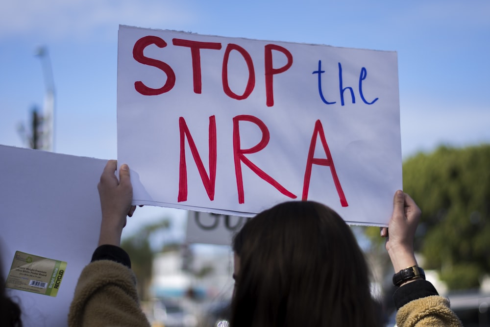 woman holding Stop the NRA banner