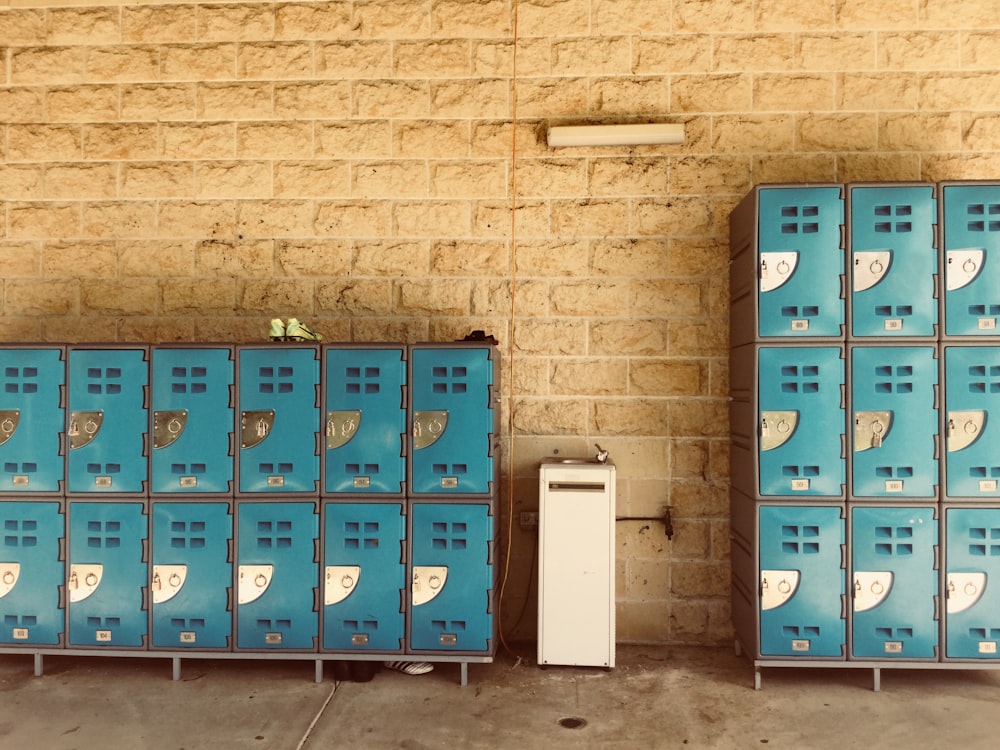 closed teal lockers with beside wall
