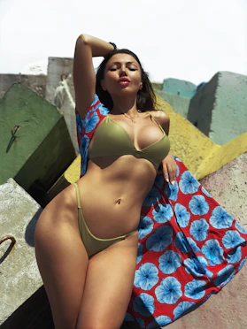 woman in green bikini sunbathing