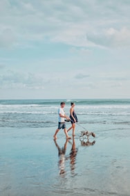 man and woman walking shore