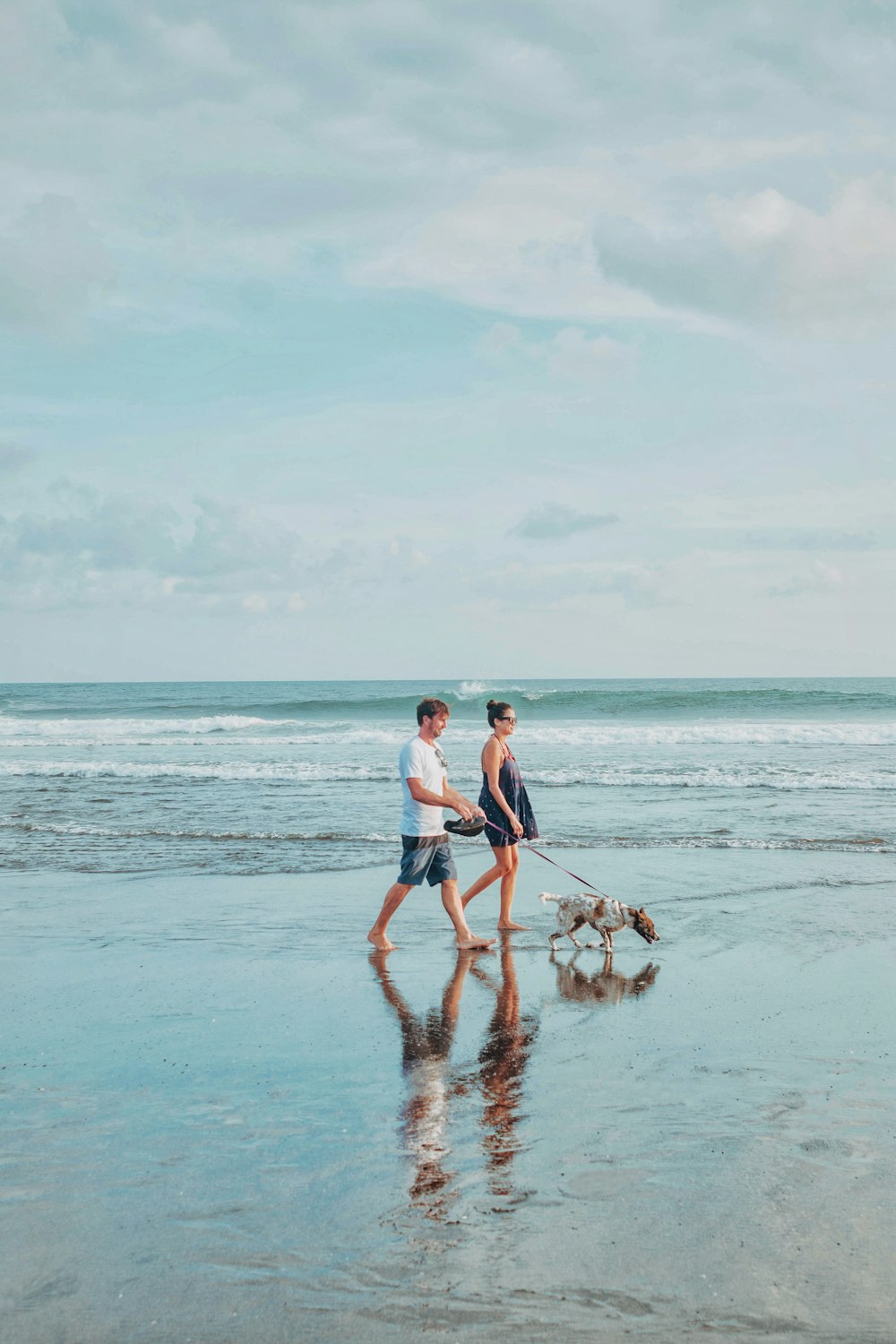 man and woman walking shore