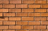 Wide shot of a residential wall under construction showing brick patterns.
