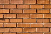 Close-up of skilled hands framing a basement wall with clean, precise cuts.