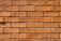 Photo of a completed brick wall construction site with clear, precise masonry work.