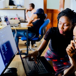 woman and man sitting in front of monitor