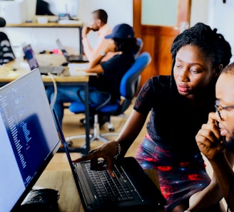 woman and man sitting in front of monitor