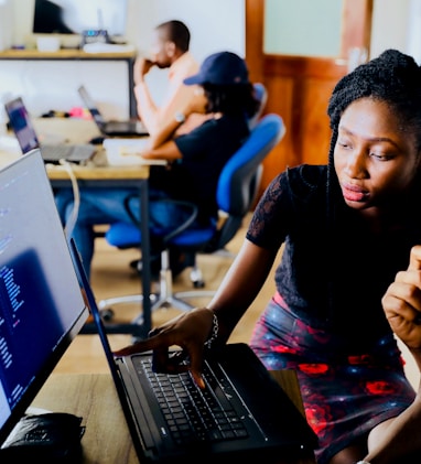 woman and man sitting in front of monitor