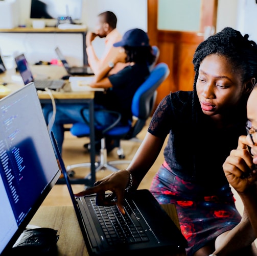 woman and man sitting in front of monitor