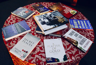 A rustic wooden table displaying a selection of donated used books.