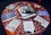 A diverse group of people engaged in a lively discussion around a table filled with books.
