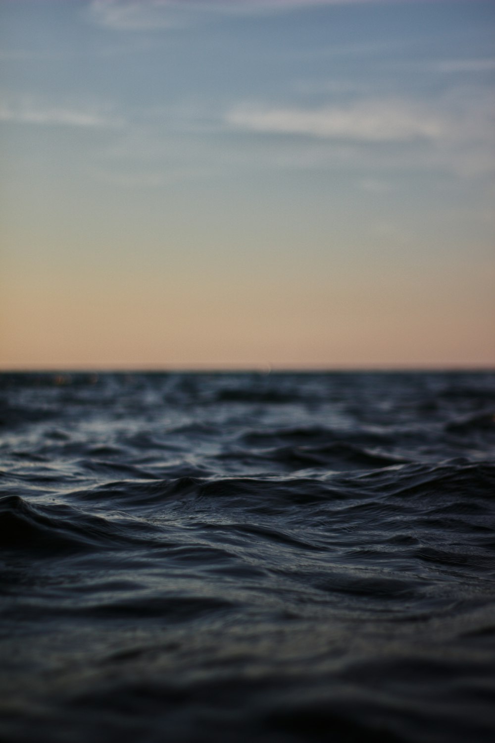 shallow focus photography of body of water