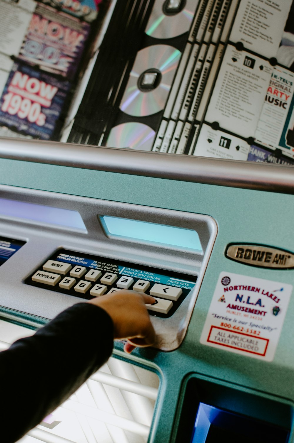 person touching white button on machine