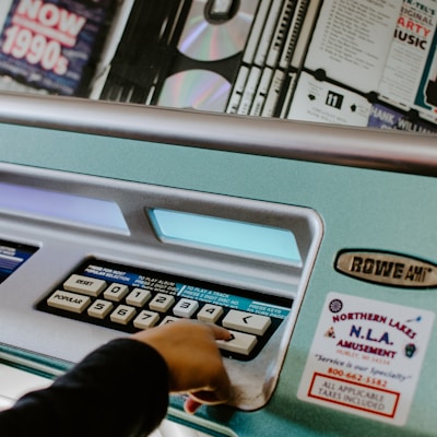 person touching white button on machine