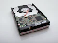 Old computer hard drive being removed for secure data destruction