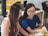 two women sitting beside table