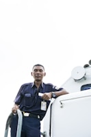 A team member inspecting a property exterior, dressed in navy blue uniform, reflecting our professional approach.