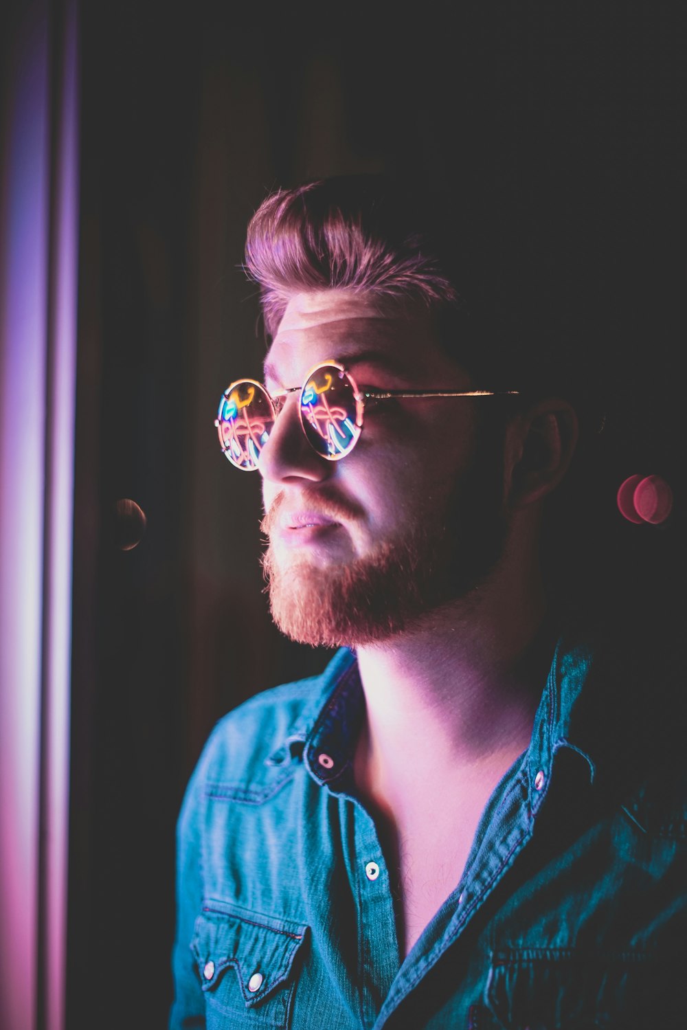 man wearing sunglasses at dim lighted room