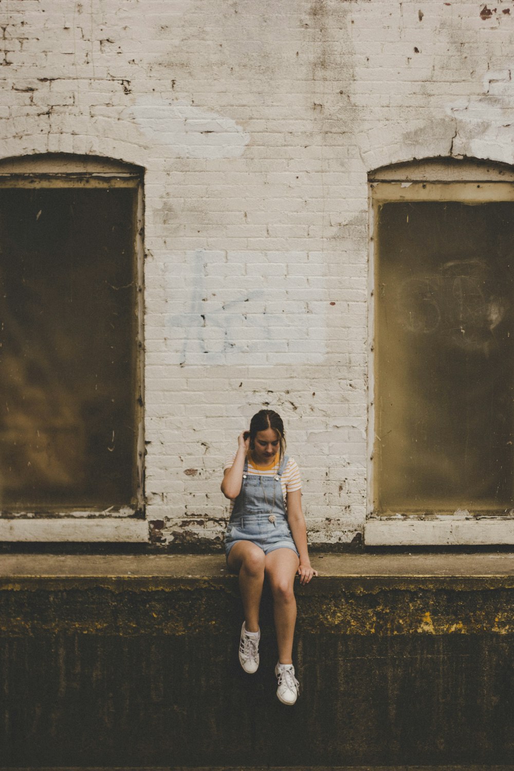 woman wearing blue denim overall shorts